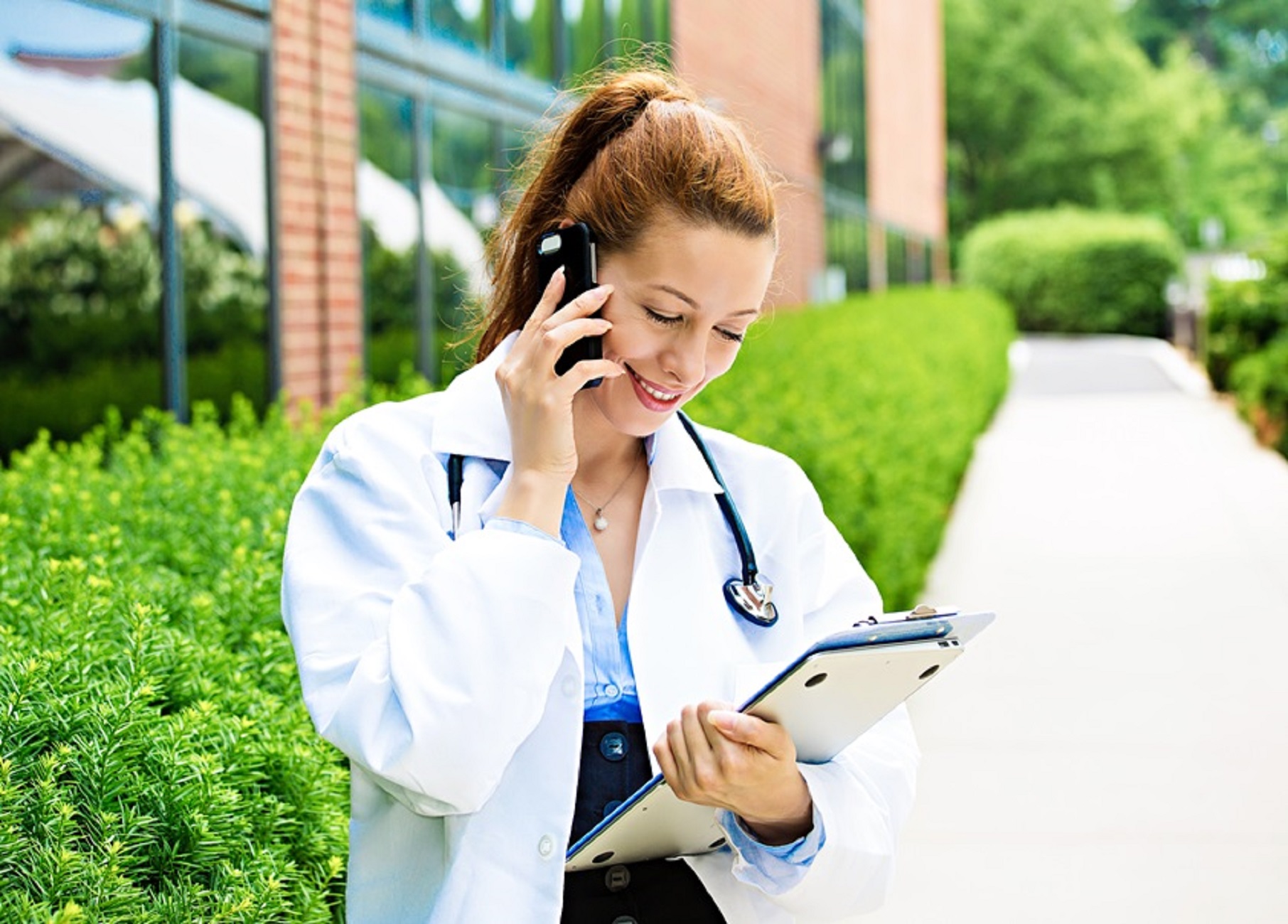 Smiling female doctor on phone
